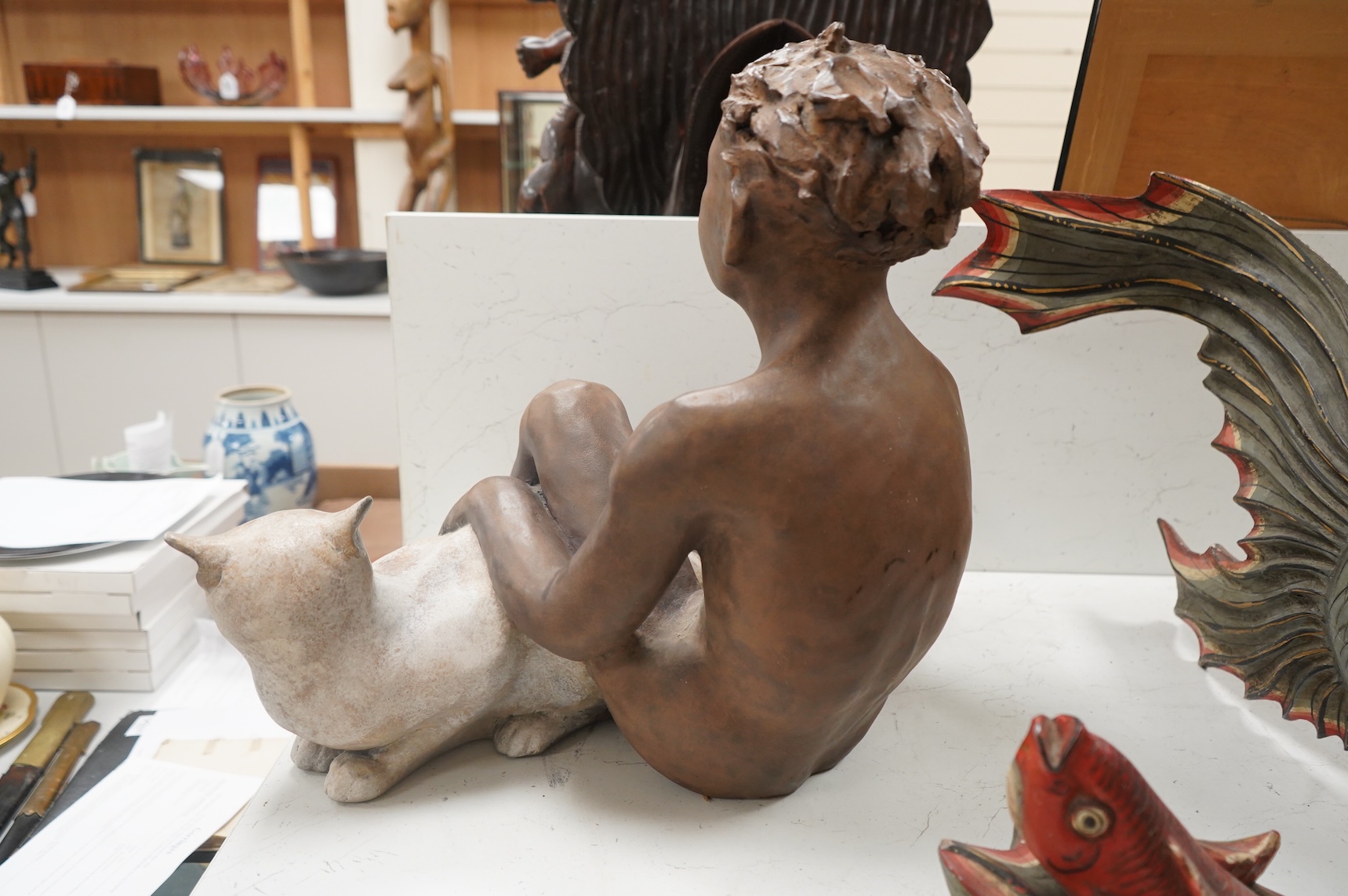 A contemporary composition figure of a seated boy and a cat, 46cm